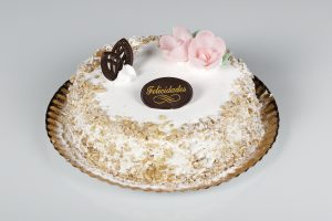 Tarta de nueces con relleno de nata y crema, y cobertura de nueces.